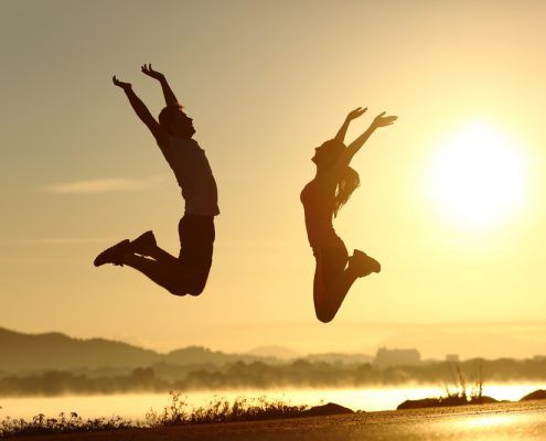 man and woman jumping